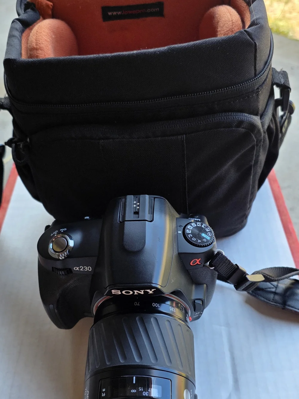 Sony Black DSLR Camera with Black Bag and Orange Interior